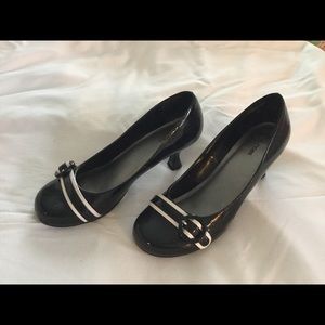Black and white patten leather pumps